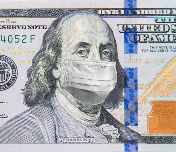 istock Benjamin Franklin in a mask on a 100 dollar bill isolated on white background. Concept of prevention of money from crisis. 2244222820