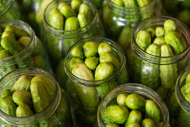istock Fresh cucumbers in glass jars ready for pickling 2244223712