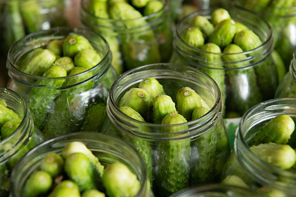 istock Fresh cucumbers in glass jars ready for pickling 2244223714