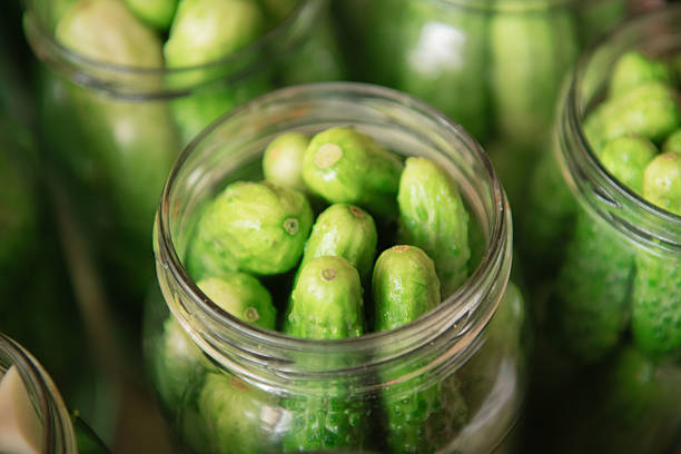 istock Fresh cucumbers in glass jars ready for pickling 2244223716