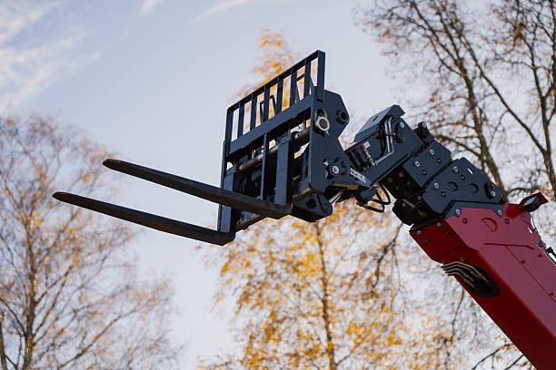 istock Telescopic handler fork attachment lifting mechanism on hydraulic boom arm used for industrial material handling and construction site logistics 2244229030