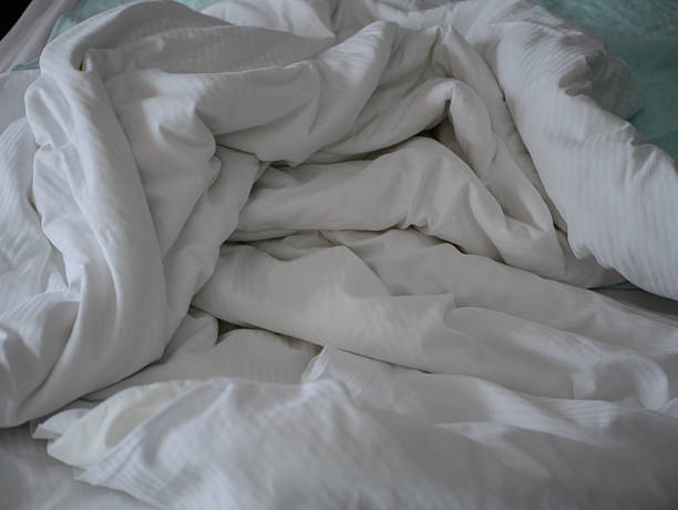 istock Unmade white hospital bed with crumpled bedding and soft natural light creating a calm clinical atmosphere in a healthcare patient recovery 2244229499