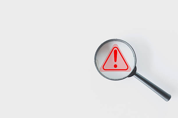 istock Focus on Prohibition: Magnifying Glass over Red Restricted Icon on White Background 2244230322