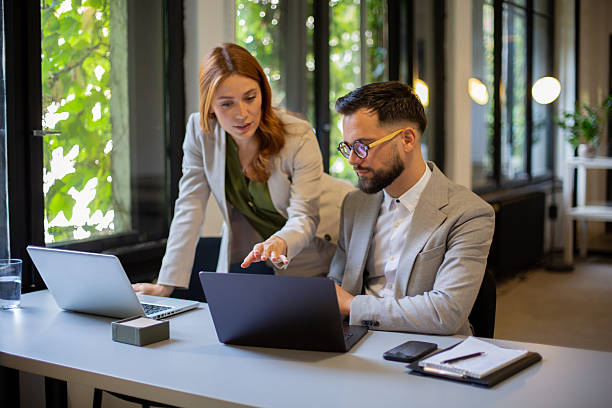 istock Business colleagues collaborating on laptop in modern office 2244231327