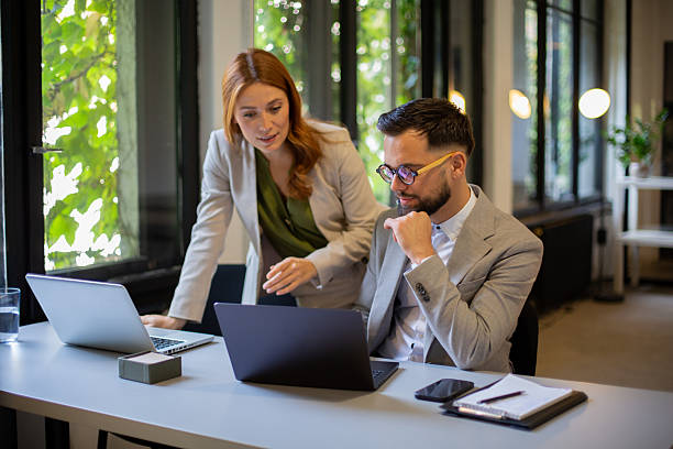 istock Business colleagues collaborating on laptop in modern office 2244231329