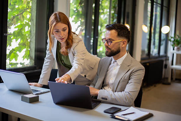istock Business colleagues collaborating on laptop in modern office 2244231462
