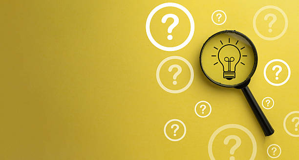 istock Finding the Solution: Magnifying Glass Focusing on Lightbulb Idea among Question Marks.,copyspace. 2244231518