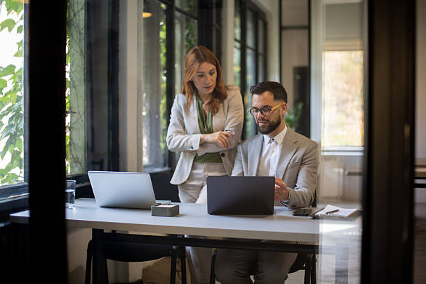 istock Business colleagues collaborating on laptop in modern office 2244231601