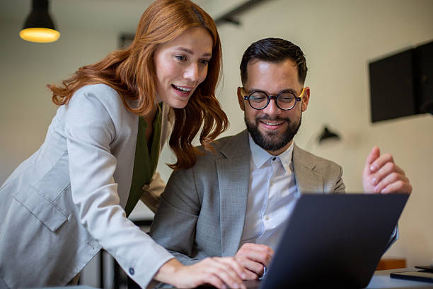istock Business colleagues collaborating on laptop in modern office 2244231615