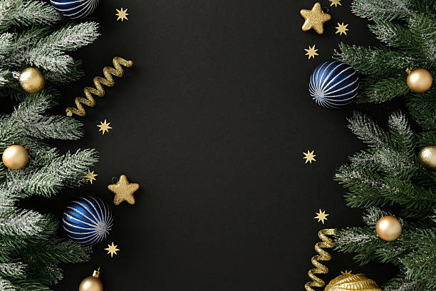 istock Luxury Christmas flat lay composition with frosted pine branches, gold and blue bauble, glitter star and ribbon on black background. Xmas banner design, New Year greeting card template 2244233230