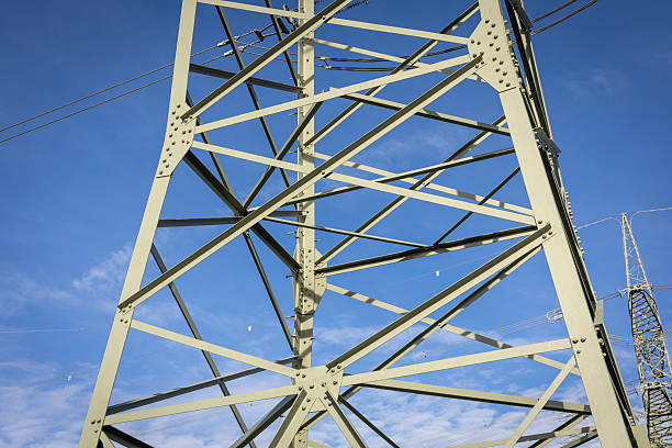 istock Steel transmission tower against a clear blue sky with intricate structural designs and supportive cables visible 2244234106