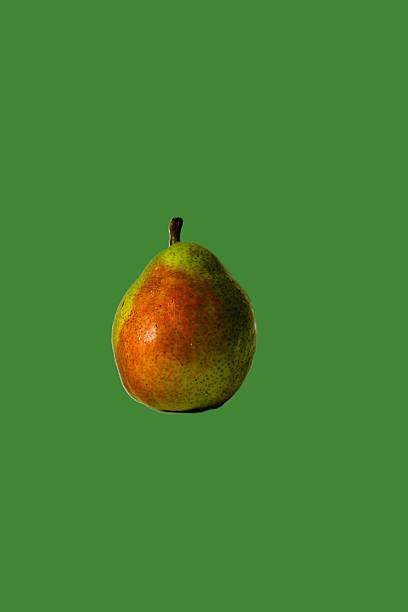 istock Isolated pear against a green background. Vertical photo with space for text 2244236515