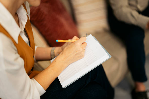 istock Therapist taking notes during a mental health counseling session 2244236786