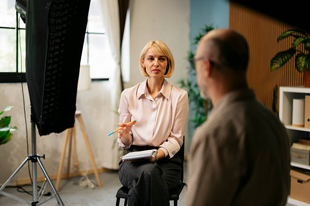 istock Woman interviewing man in studio setting for podcast or talk show 2244236844