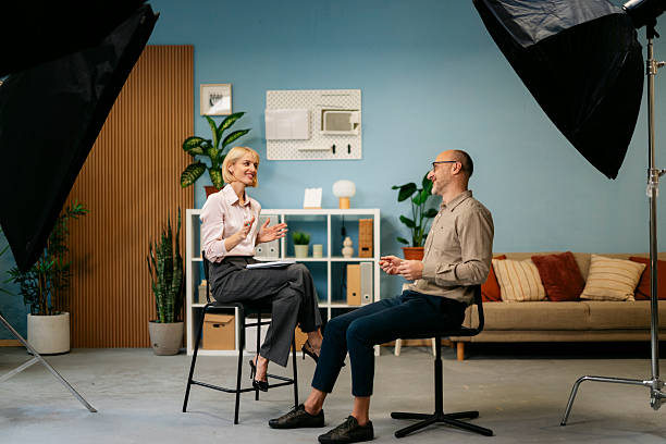 istock Woman interviewing man in professional studio for podcast 2244236863