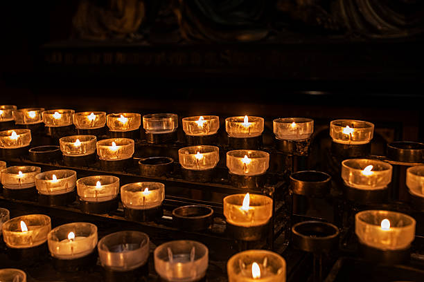 istock Lit candles in a church during Christmas 2244237000