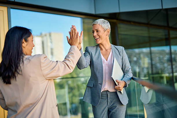 istock Businesswomen celebrating successful teamwork with a high five 2244237098