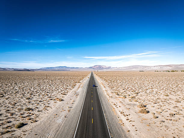 istock Lonely car driving through desert highway in Nevada 2244239961