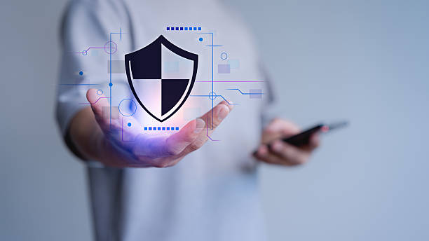 istock Person holds a digital shield icon, symbolizing cybersecurity, mobile data protection, and modern digital privacy solutions. Certified guarantee approval or secure access system concept. 2244241079