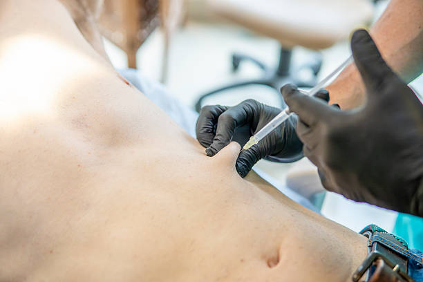 istock Doctor applying anesthesia to a patient's abdomen 2244242508