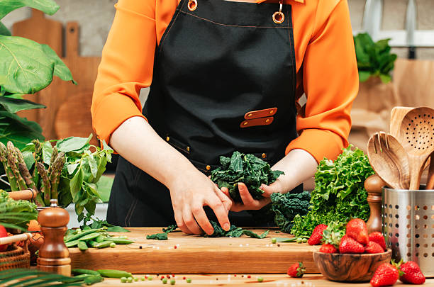 istock skilled private chef expertly chops fresh vegetables and herbs on wooden cutting board in bright kitchen, creating healthy dishes 2244246152