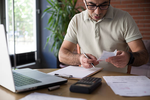 istock Man reviewing financial documents at home 2244247334