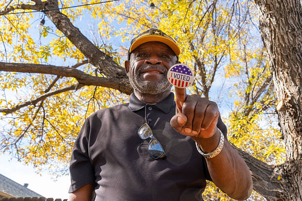 istock Proud citizen displays voting sticker. Autumn election day celebration. 2244252269