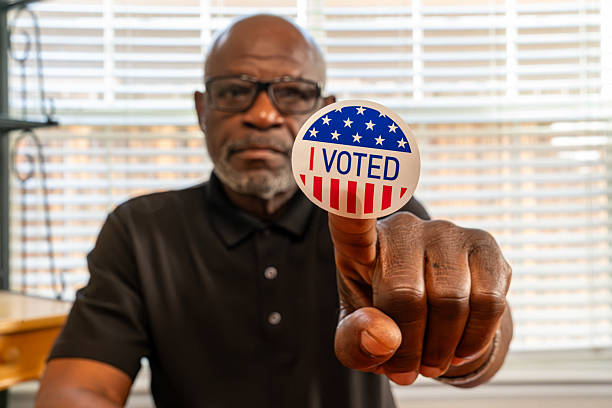 istock Civic participation. Senior citizen displays voting badge. 2244252385