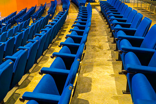 Stadium seats, blue color. Soccer, football or baseball stadium tribune without fans. End of the game.