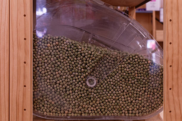 Dry green peas in a bulk bin in the bulk food section.