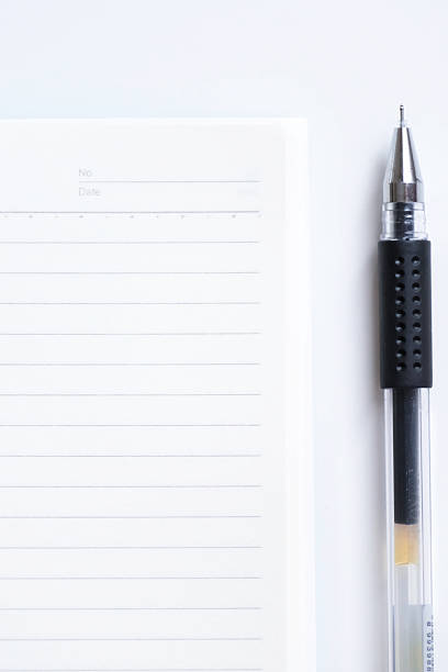 istock Close-up of blank notebook and pen isolated on white background 2244254835