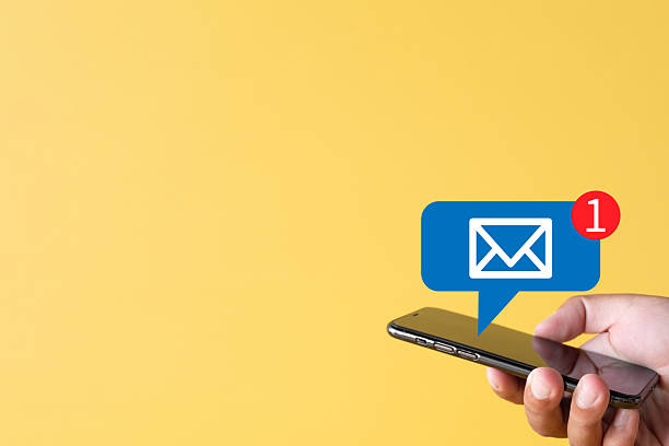 istock New Email Notification: Hand Holding Smartphone with Inbox Message Alert on Yellow Background 2244255690