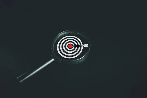 istock Focus on Goal: Magnifying Glass over Target Icon for Business Strategy on Dark Background 2244256679