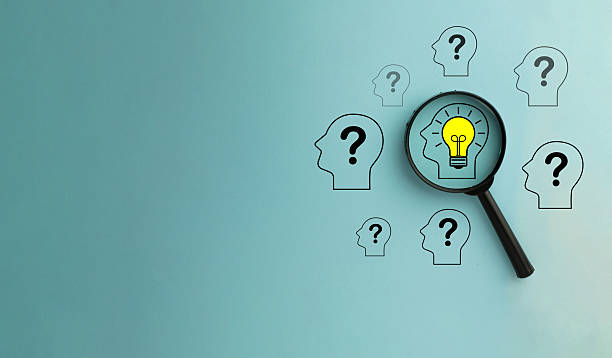 istock Finding the Solution: Magnifying Glass Focusing on Lightbulb Idea among Question Marks.,copyspace. 2244256686
