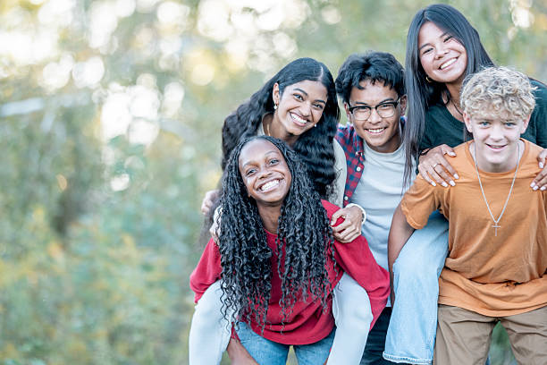 istock Diverse Group Of Teens Smiling Together Outdoors In A Park 2244258643