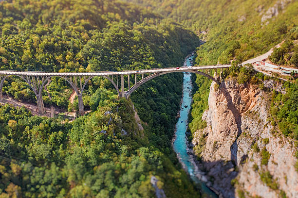 Durdevica Bridge connecting mountainous landscapes, overlooking the turquoise Tara River flowing through the deep canyon