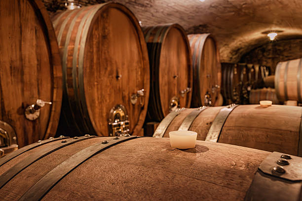 istock Wine barrels aging in a traditional underground cellar, showcasing the winemaking process and a rustic, authentic atmosphere 2244258867