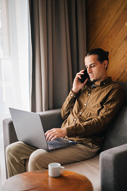 istock Young man in a comfort room working on his laptop. 2244258953