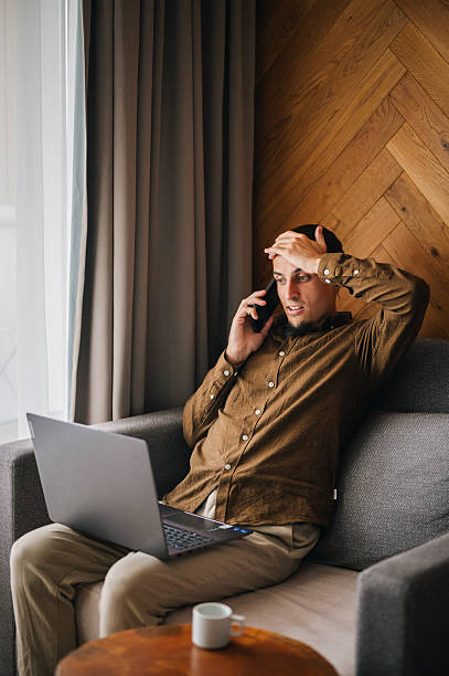 istock Young man in a comfort room working on his laptop. 2244258976