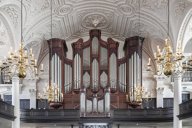 London, UK - Jul 12, 2025 - A magnificent Georgian architecture of St Martin-in-the-Fields including with arched ceilings, Corinthian columns and The large organ prominently.