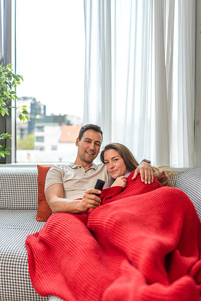istock Cozy Couple Relaxing Together on a Sofa 2244260008
