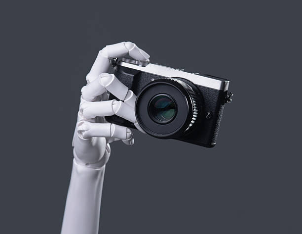istock Robot Hand Holding a Digital Camera: AI Vision, Technology, and Future Photography Concept 2244261184