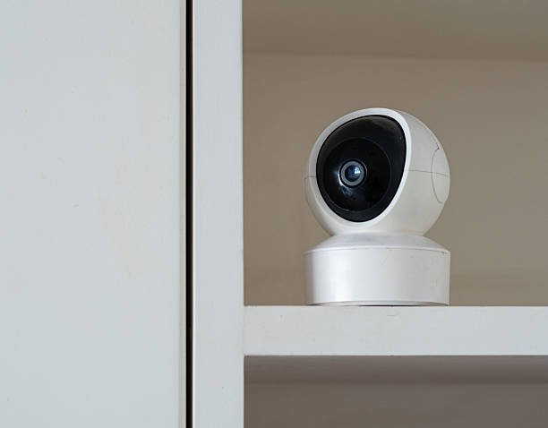 istock White Smart Home Security Camera Monitoring an Indoor Shelf 2244262070