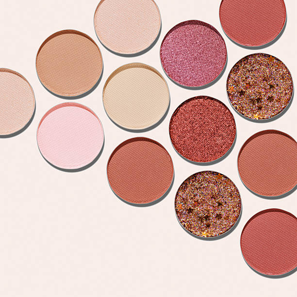 istock Colorful Swatches eyeshadow refills as minimal geometric pattern. Matte, glitter pans red brown pink shade with sun shadows, detailed texture, cosmetic, beauty product, makeup, warm color scheme 2244262875