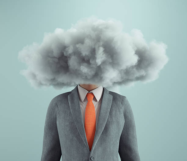 istock Businessman with a cloud for a head representing confusion and uncertainty in the workplace at a creative office 2244263525