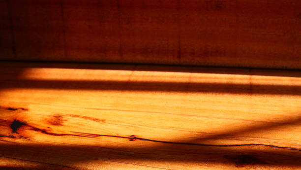 istock Dramatic Contrasting Light and Shadow on Rich, Warm Wooden Surface 2244263777