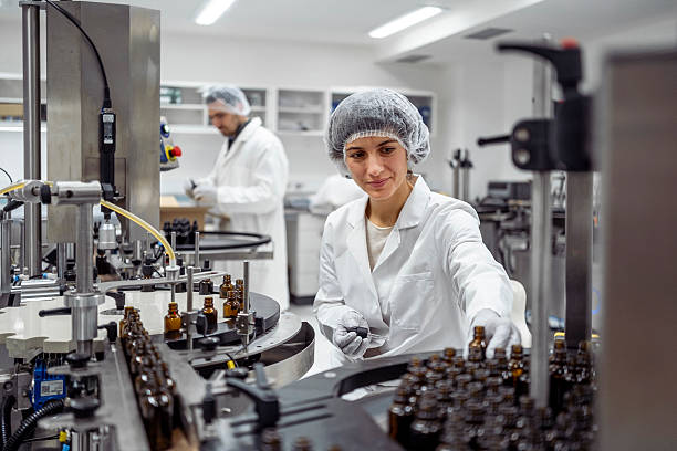 istock Mid Adult Female Lab Worker in White Coat Packaging Products in Modern Laboratory Setting 2244264124