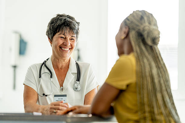 istock Smiling White-Coated Doctor With Stethoscope Interacting Warmly With Patient At Clinic 2244264134