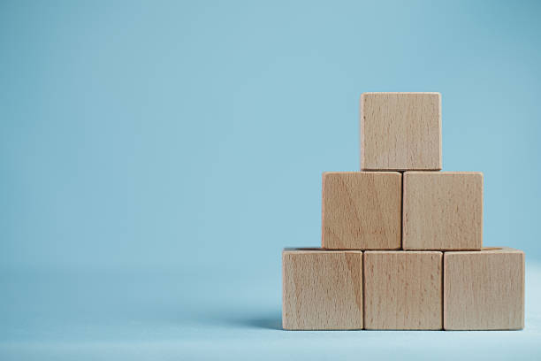 istock Business Hierarchy Mockup: Blank wooden block pyramid on blue background with copy space. 2244264915