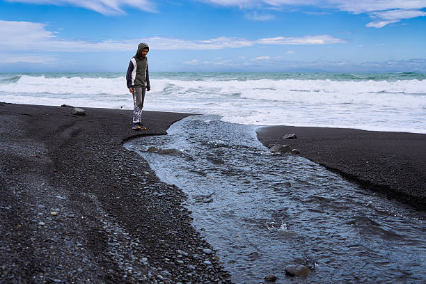 istock Kid enjoying the beautiful day the beach 2244267171